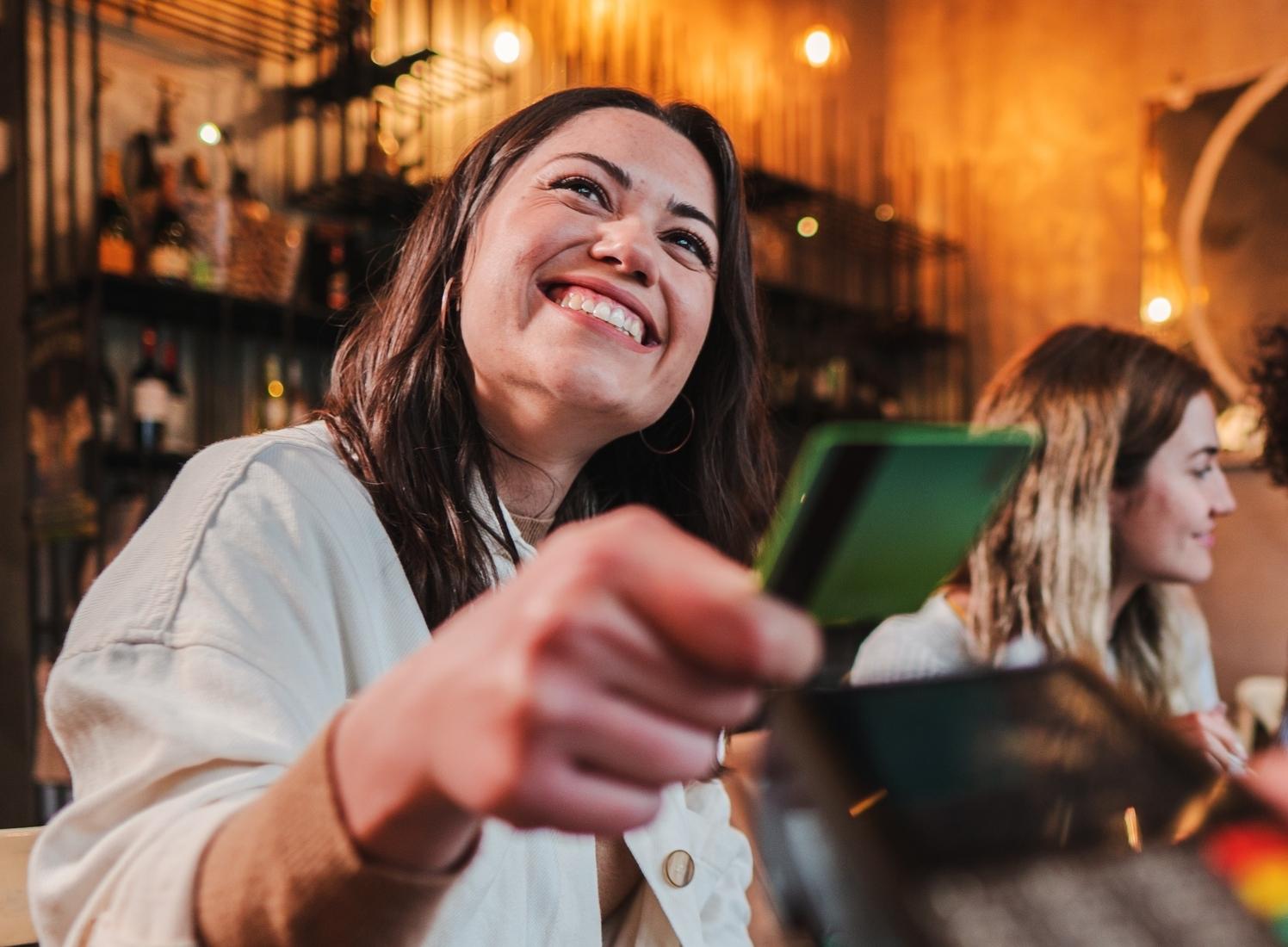 Person using a debit card at restaurant