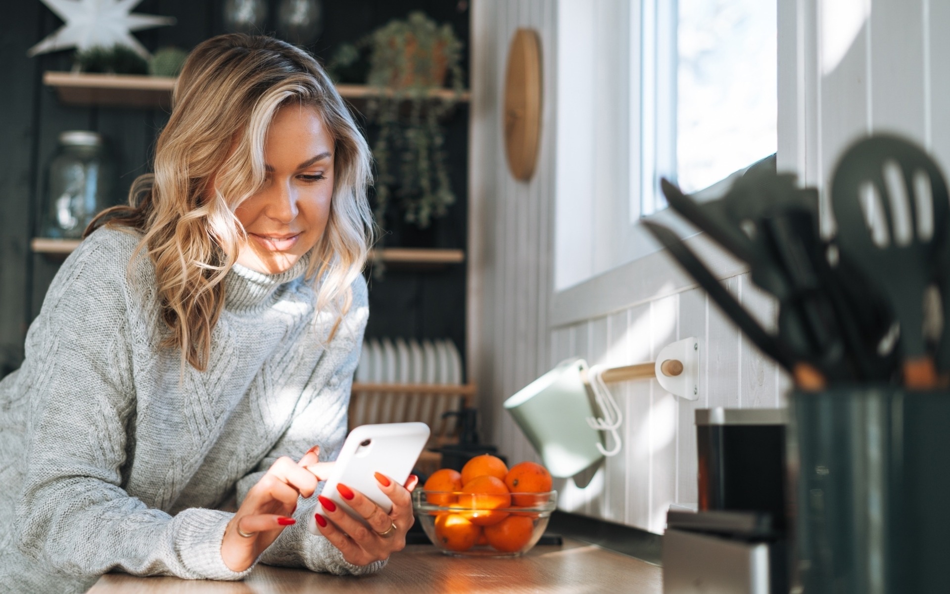 Woman on phone in kitchen